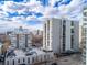 An exterior view of a high rise condominium featuring a rooftop parking structure on a clear day at 777 N Washington St # 204, Denver, CO 80203