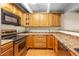 A kitchen featuring wooden cabinets, countertops, and stainless steel appliances at 777 N Washington St # 204, Denver, CO 80203
