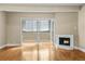 A living room featuring hardwood floors, a fireplace, and a sliding glass door to a balcony at 777 N Washington St # 204, Denver, CO 80203
