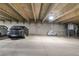 A parking garage with assigned parking including parking for a motorcycle and a grey sedan at 777 N Washington St # 204, Denver, CO 80203