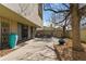 Private outdoor patio with mature trees, and metal furniture at 777 N Washington St # 204, Denver, CO 80203
