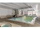 Indoor community pool and hot tub with lounge area and plenty of natural light at 777 N Washington St # 204, Denver, CO 80203