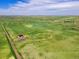 Stunning aerial view of a beautiful home nestled in a vast, serene landscape at 2400 Ventress Ct, Bennett, CO 80102