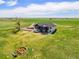 Expansive property featuring a modern farmhouse with a fire pit and beautiful country views at 2400 Ventress Ct, Bennett, CO 80102