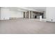 Large finished basement with a wet bar and neutral colored carpet at 2400 Ventress Ct, Bennett, CO 80102