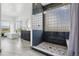 Stylish bathroom features a glass shower, soaking tub, double sink, and views of the surrounding landscape at 2400 Ventress Ct, Bennett, CO 80102