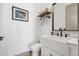 Modern bathroom with white vanity, matte black faucet, minimalist decor, and toilet at 2400 Ventress Ct, Bennett, CO 80102
