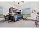 room with a sturdy bunk bed, writing desk, fun decor, and a big bright window with a view at 2400 Ventress Ct, Bennett, CO 80102