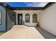 Inviting entrance with a black front door, arched windows, and a cozy covered porch area at 2400 Ventress Ct, Bennett, CO 80102