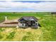 Aerial view of home with lush green landscaping and a large back porch, providing ample outdoor living space at 2400 Ventress Ct, Bennett, CO 80102
