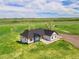 Aerial view of home with lush green landscaping, a paved driveway, and manicured grounds at 2400 Ventress Ct, Bennett, CO 80102