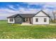 Charming farmhouse exterior with blue and white siding, arched windows, and a welcoming front porch at 2400 Ventress Ct, Bennett, CO 80102