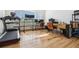 Bright home office features a treadmill, hardwood floors and large windows at 2400 Ventress Ct, Bennett, CO 80102