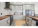 Well-equipped kitchen featuring gray cabinets, stainless steel appliances, and a herringbone backsplash at 2400 Ventress Ct, Bennett, CO 80102