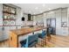 Bright kitchen boasts a large island, gray cabinets, patterned backsplash, and stainless steel appliances at 2400 Ventress Ct, Bennett, CO 80102