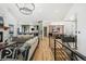 Bright and airy living space connecting to the kitchen and dining area, featuring hardwood floors at 2400 Ventress Ct, Bennett, CO 80102