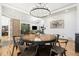Open-concept living space with hardwood floors, modern lighting, and a comfortable seating area at 2400 Ventress Ct, Bennett, CO 80102