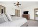 Cozy main bedroom with large windows, ceiling fan, and warm neutral tones, creating a peaceful retreat at 2400 Ventress Ct, Bennett, CO 80102