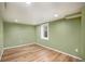 Basement room featuring updated flooring, natural light, and neutral color scheme at 1449 Clinton St, Aurora, CO 80010