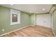 Basement bedroom featuring updated flooring, natural light, and closet at 1449 Clinton St, Aurora, CO 80010