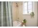 Bathroom with shower over tub, rainfall shower head and tiled walls at 1449 Clinton St, Aurora, CO 80010