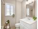 Cozy bathroom features a white vanity, neutral tiling, and modern fixtures at 1449 Clinton St, Aurora, CO 80010