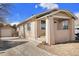 Exterior view showcasing the house, driveway, and detached garage at 1449 Clinton St, Aurora, CO 80010