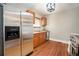 Well-lit kitchen with stainless steel refrigerator and wood cabinetry at 1449 Clinton St, Aurora, CO 80010