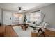 Inviting living room with hardwood floors, ceiling fan, and natural light from the large window at 1449 Clinton St, Aurora, CO 80010