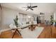 Bright living room with hardwood floors, ceiling fans, and an open view to the kitchen at 1449 Clinton St, Aurora, CO 80010