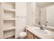 White-walled bathroom showcasing built in shelves and single sink with counter space at 452 Black Feather Loop # 612, Castle Rock, CO 80104