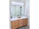 Well-lit bathroom featuring a dual sink vanity with wood cabinets, a large mirror, and neutral decor at 452 Black Feather Loop # 612, Castle Rock, CO 80104