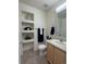 Cozy bathroom with built-in shelves, neutral flooring, updated fixtures, and vanity storage at 452 Black Feather Loop # 612, Castle Rock, CO 80104