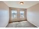 A carpeted bedroom features two sunny windows with neighborhood views and neutral walls at 452 Black Feather Loop # 612, Castle Rock, CO 80104