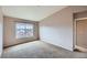 A carpeted bedroom includes a sunny window with neighborhood views and neutral colored walls at 452 Black Feather Loop # 612, Castle Rock, CO 80104
