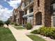 Beautiful multi-story townhomes featuring stone accents, well-maintained landscaping, and inviting entryways at 452 Black Feather Loop # 612, Castle Rock, CO 80104