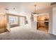 Open concept living area, showing fireplace, sliding glass doors and adjacent kitchen at 452 Black Feather Loop # 612, Castle Rock, CO 80104