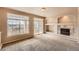 Bright living room featuring a fireplace, decorative shelving and sliding glass doors to balcony at 452 Black Feather Loop # 612, Castle Rock, CO 80104