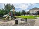 Community playground features a slide, climbing structure, and play equipment for children at 452 Black Feather Loop # 612, Castle Rock, CO 80104