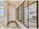 Inviting entryway featuring wood floors and large decorative mirrors reflecting natural light into the home at 13838 Honey Hush Trl, Parker, CO 80134