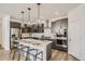 Modern kitchen with stainless steel appliances, a center island with seating, and stylish pendant lighting at 13838 Honey Hush Trl, Parker, CO 80134