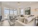 Bright living room with a comfortable sofa, chairs, and a sliding glass door leading to a balcony at 13838 Honey Hush Trl, Parker, CO 80134