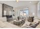 Cozy living room with a fireplace, comfortable seating, and a view to the outside balcony at 13838 Honey Hush Trl, Parker, CO 80134