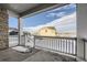 Wide angle view from the covered patio, showing snow-covered yard and newly built homes in the distance at 13838 Honey Hush Trl, Parker, CO 80134