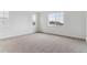 Spacious bedroom featuring neutral carpet and ample natural light from the large windows at 39172 Clymer St, Elizabeth, CO 80107