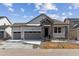 Charming single-Gathering home with stone accents, attached two-car garage, and a covered porch at 39172 Clymer St, Elizabeth, CO 80107