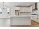 Bright kitchen with an island, stainless steel appliances, and shaker style cabinets at 39172 Clymer St, Elizabeth, CO 80107