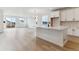 Open-concept kitchen with an island, and stainless steel appliances adjoining to a living room at 39172 Clymer St, Elizabeth, CO 80107