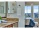 Bathroom vanity with granite countertop and access to the primary bedroom at 4000 Donnington Cir, Castle Rock, CO 80104