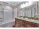 Bathroom featuring double sinks with granite counters and a bathtub and shower combination at 4000 Donnington Cir, Castle Rock, CO 80104